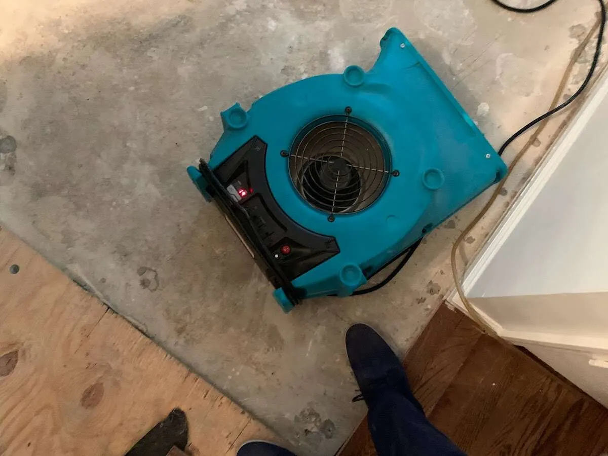 Air mover drying subfloor during Commercial Water Damage Restoration in Withamsville